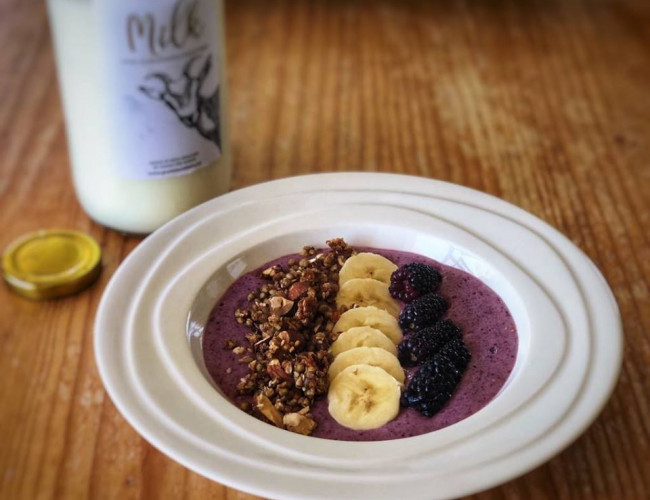 goats milk smoothie bowl with crunchy sesame and buckwheat granola