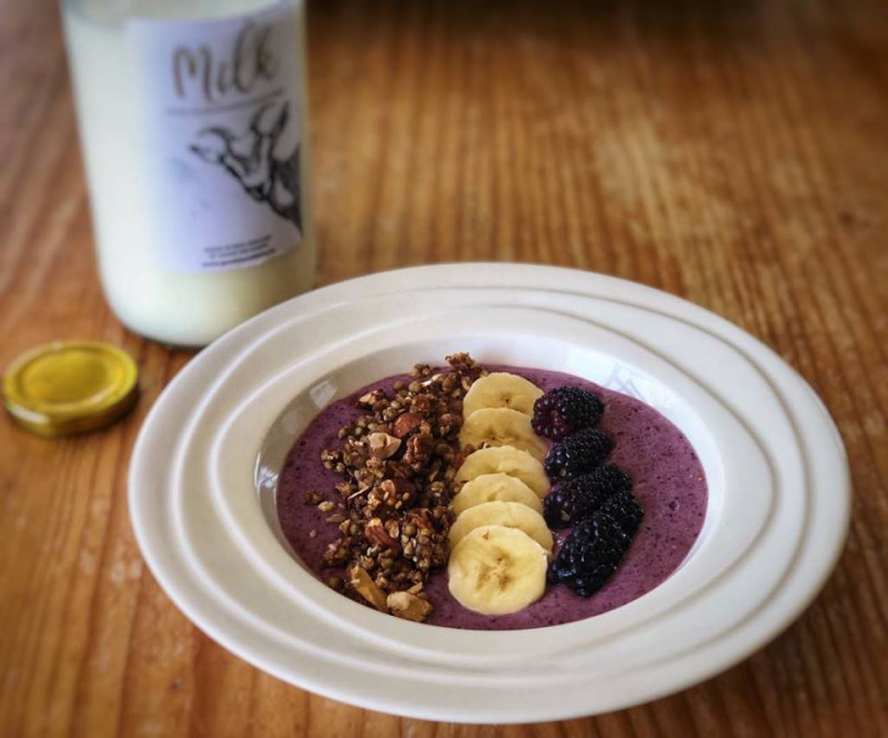 goats milk smoothie bowl with crunchy sesame and buckwheat granola