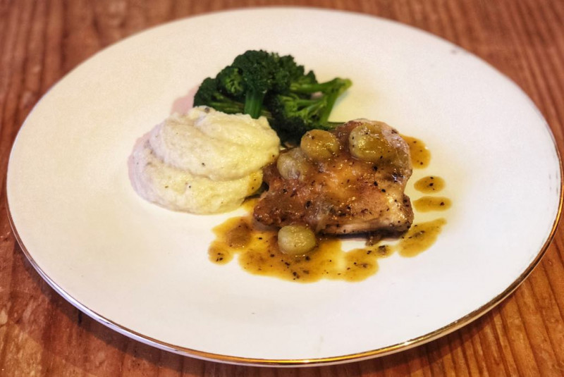 roasted chicken thigh with artichoke puree and gooseberry sauce