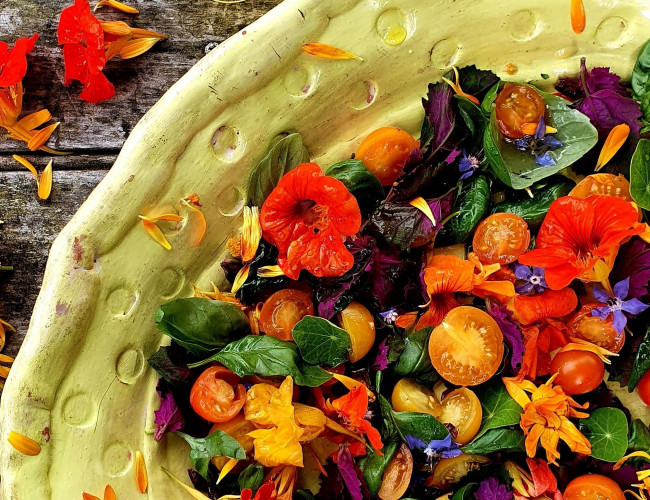 strawberry tomatoes with edible flowers and elderflower dressing