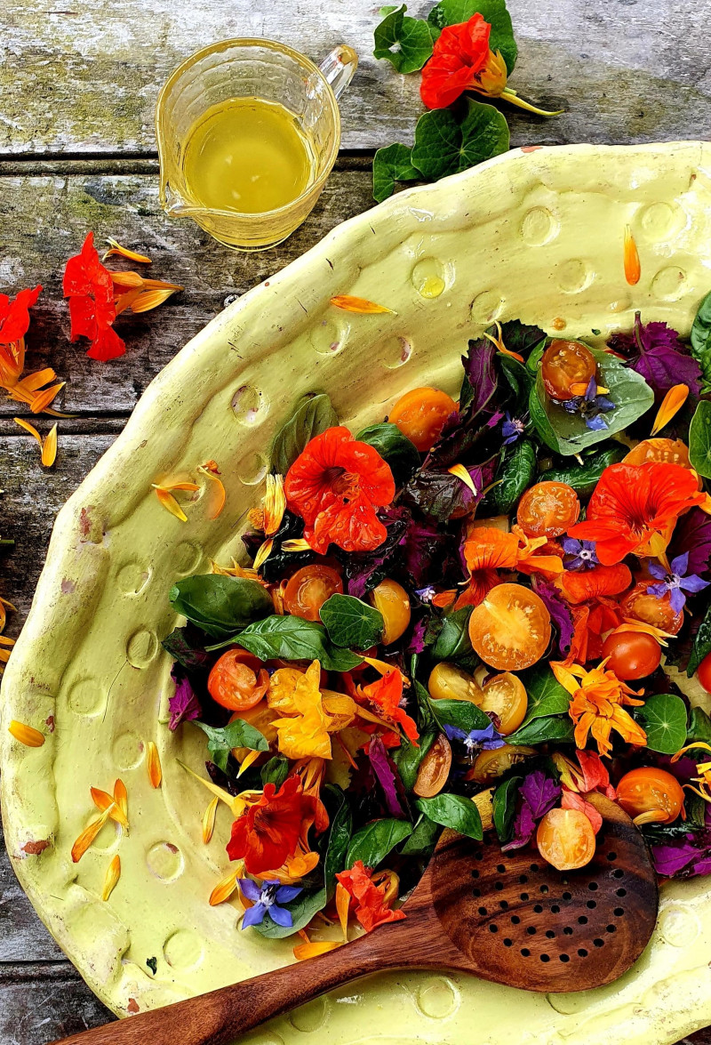 strawberry tomatoes with edible flowers and elderflower dressing