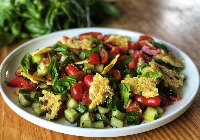 tomato cucumber and basil salad with parmesan and seed crisps