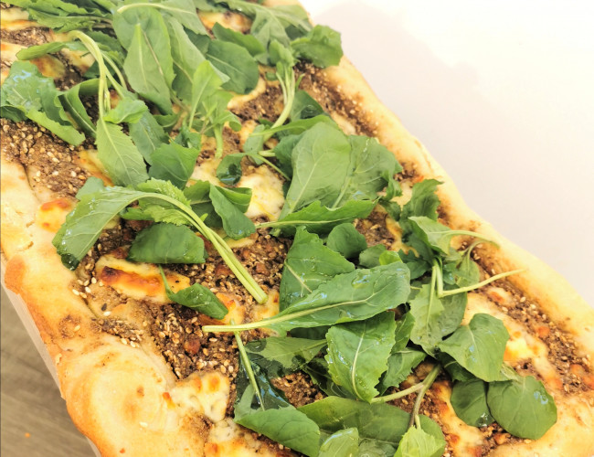 za atar and curd cheese pizza with rocket