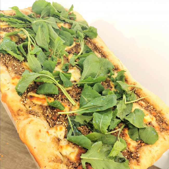 za atar and curd cheese pizza with rocket